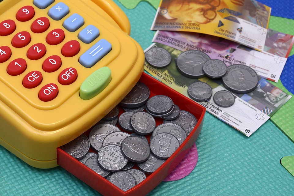 A toy cash register and play money