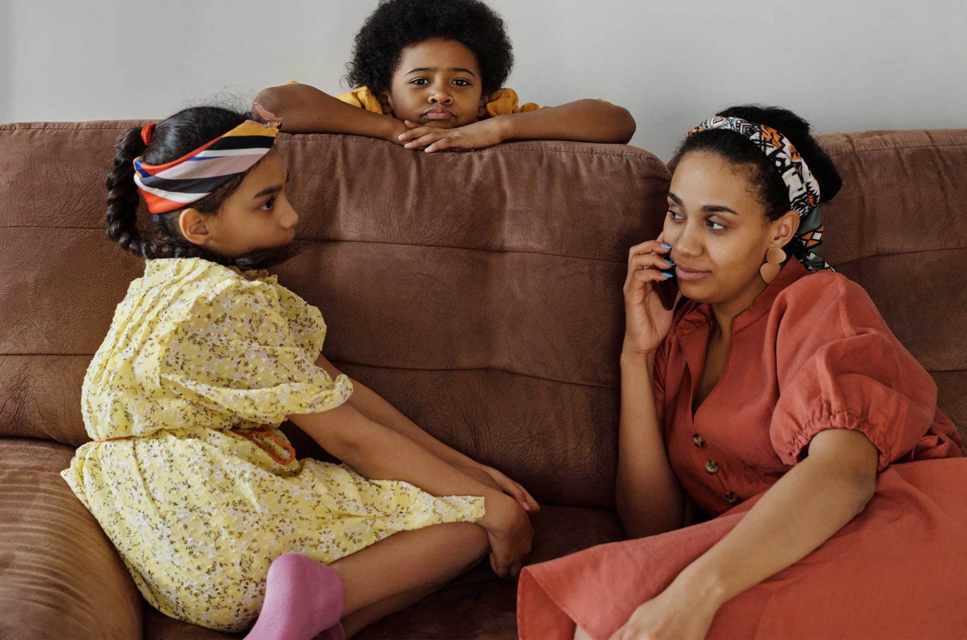 Children with their mother on a sofa