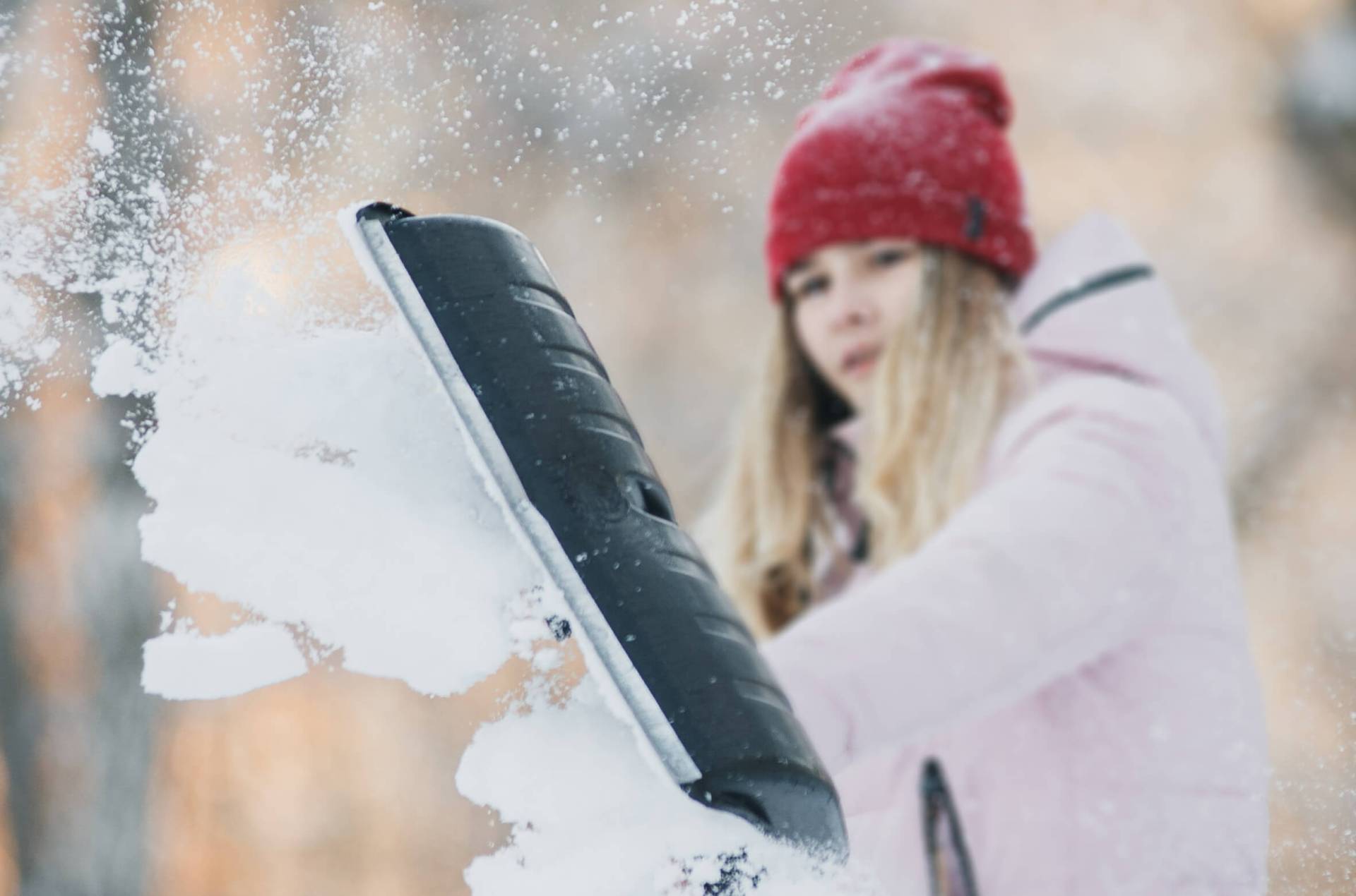 Girl shovelling snow as a chore for allowance