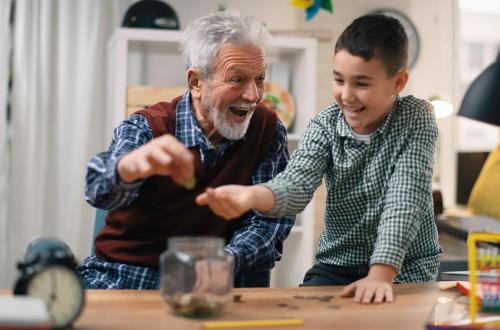 A grandpa giving his grandson an allowance