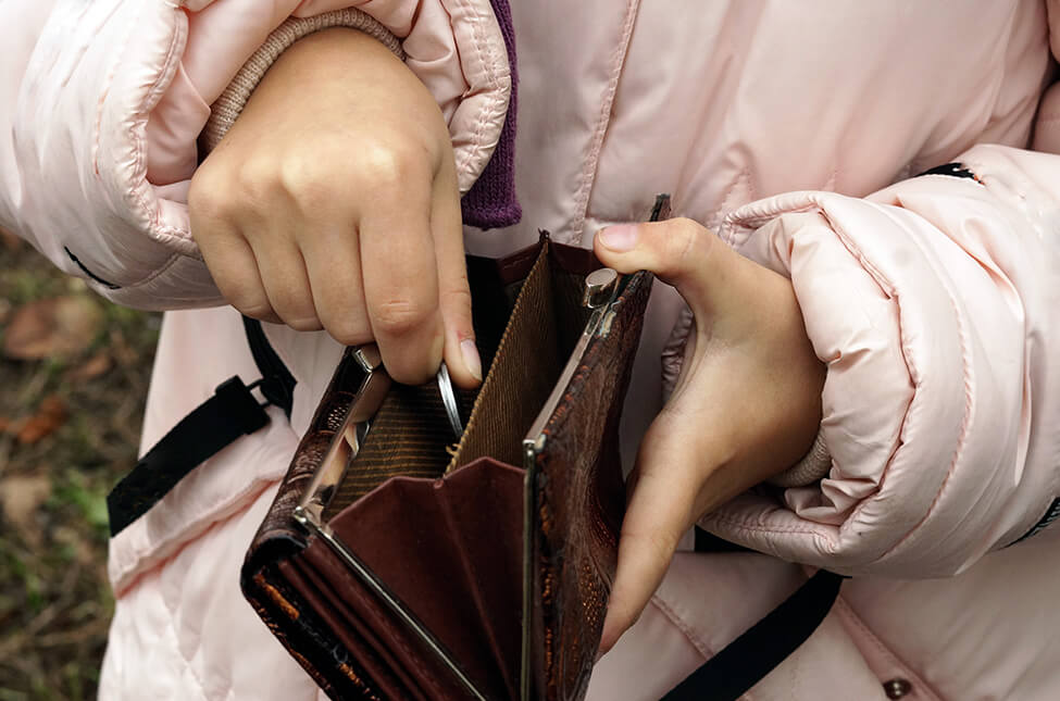 A child putting pocket change in her purse