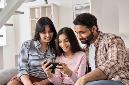 A daughter using the Mydoh money app with her parents