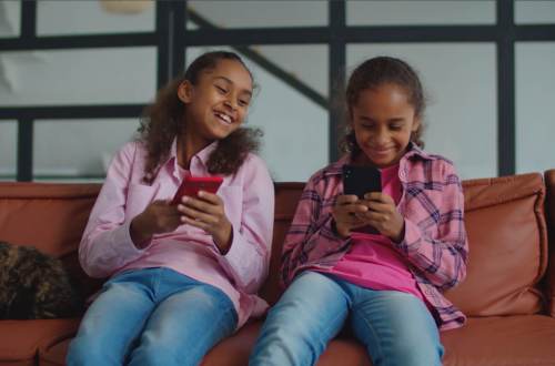 Two kids using the Mydoh money app together
