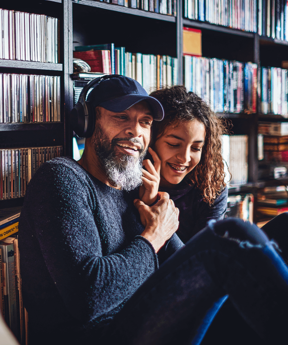 A father and his daughter listening to music together