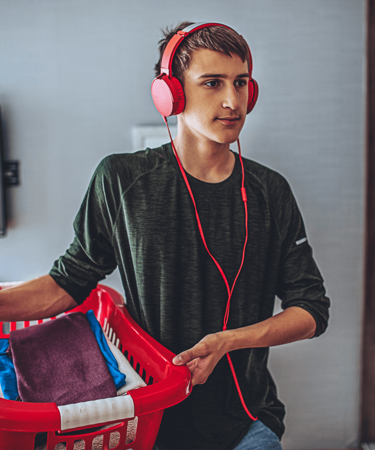 A young teenager doing laundry at home
