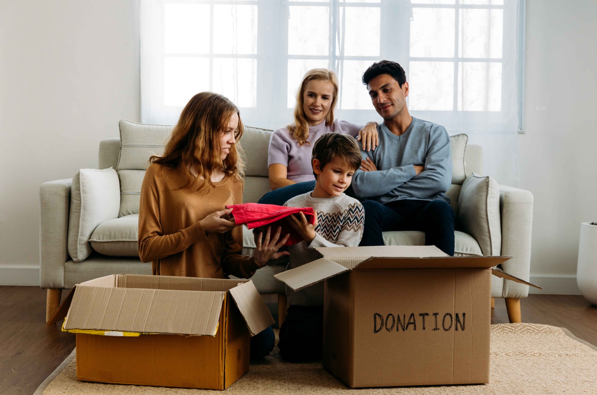 Parents and their children donating old clothes