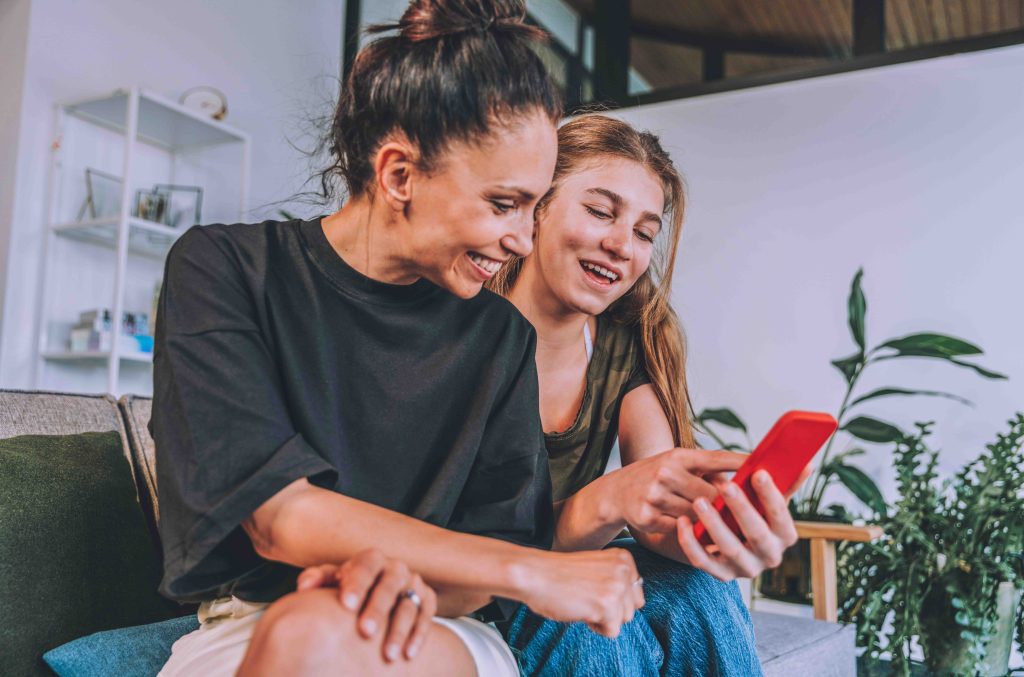 A mom and daughter reviewing daily chores and routines on a phone