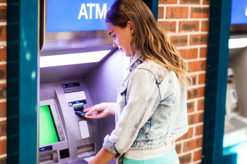 student withdrawing cash at an ATM