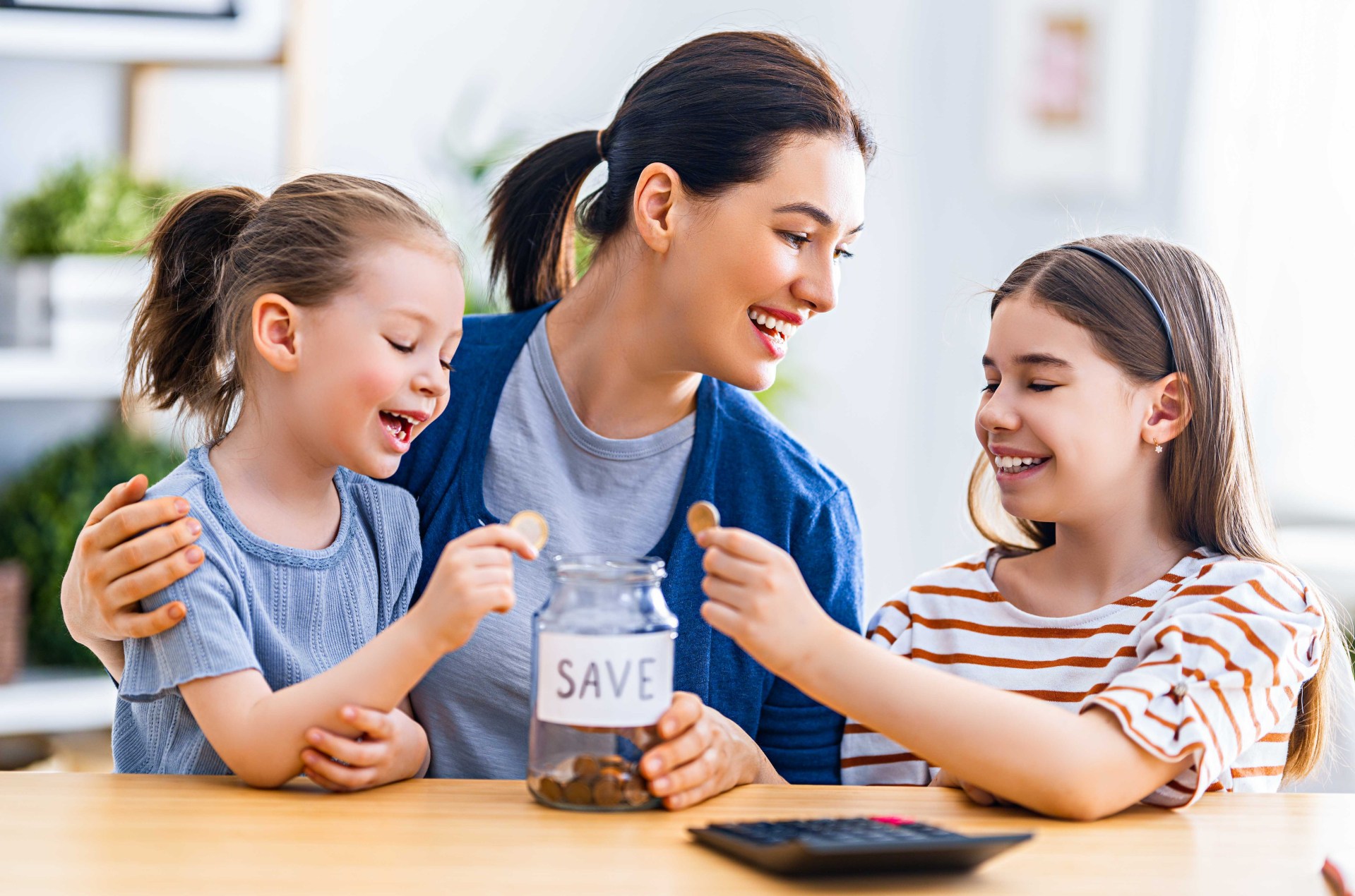 Woman and children are sitting at the desk with a paper receipt