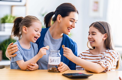 Woman and children are sitting at the desk with a paper receipt