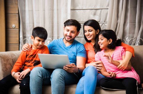 Indian family sitting on sofa