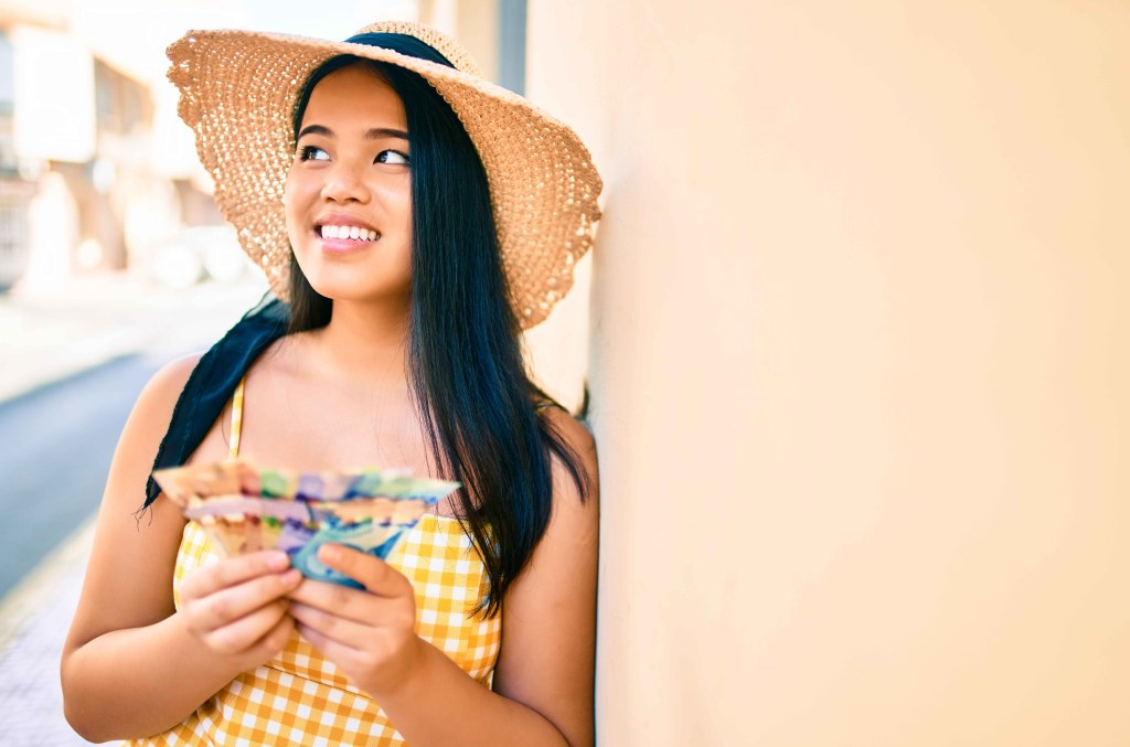 teen girl holding cash