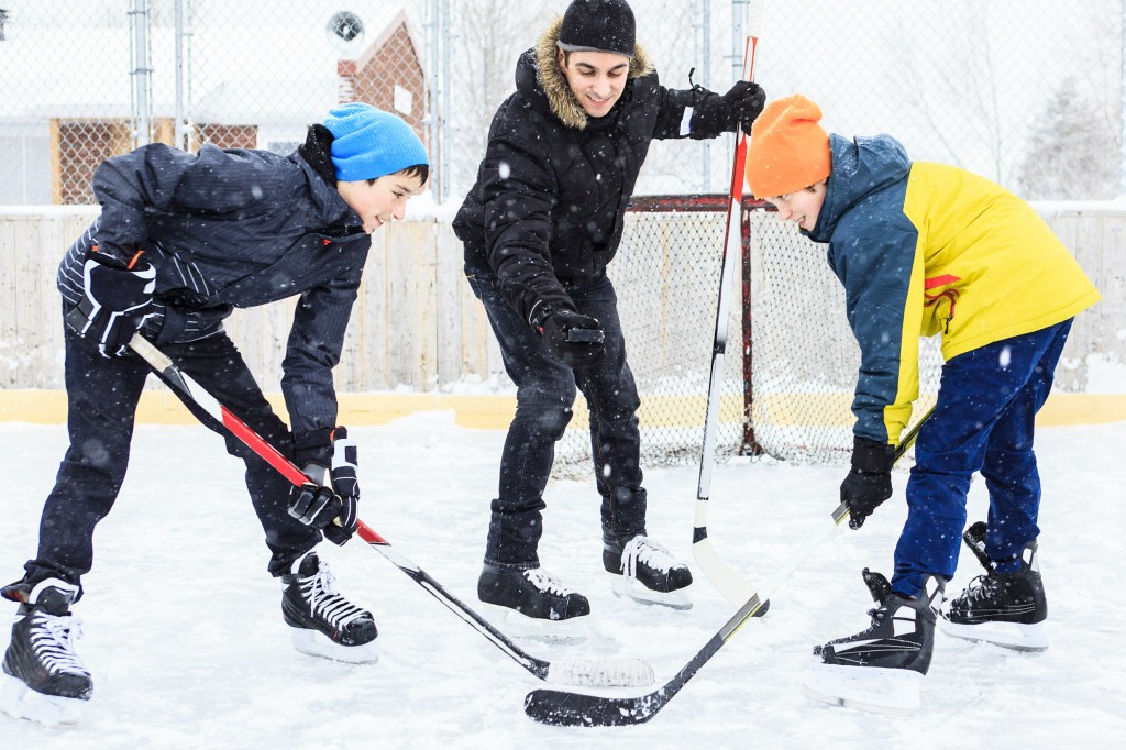 A family playing hockey outside for free