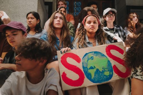 Group of teens holding signs campaigning for climate change