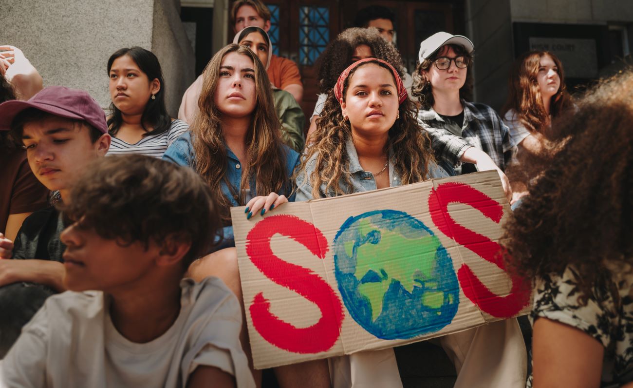 Group of teens holding signs campaigning for climate change