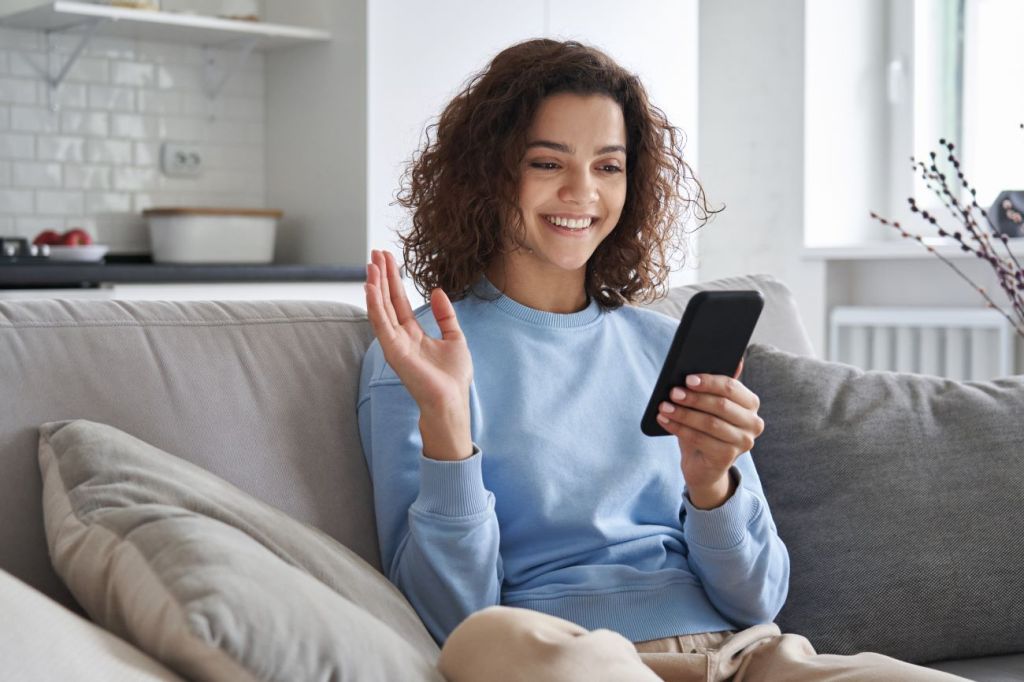 A young teen learning to invest using an practice account on a mobile phone