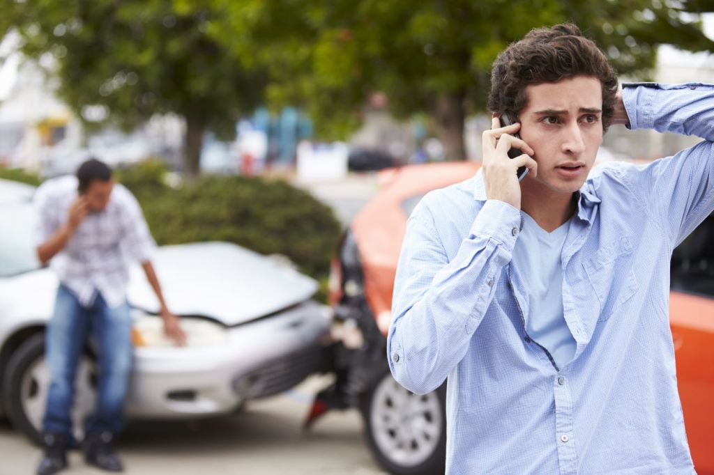 A kid talking to his insurance company after a car accident 
