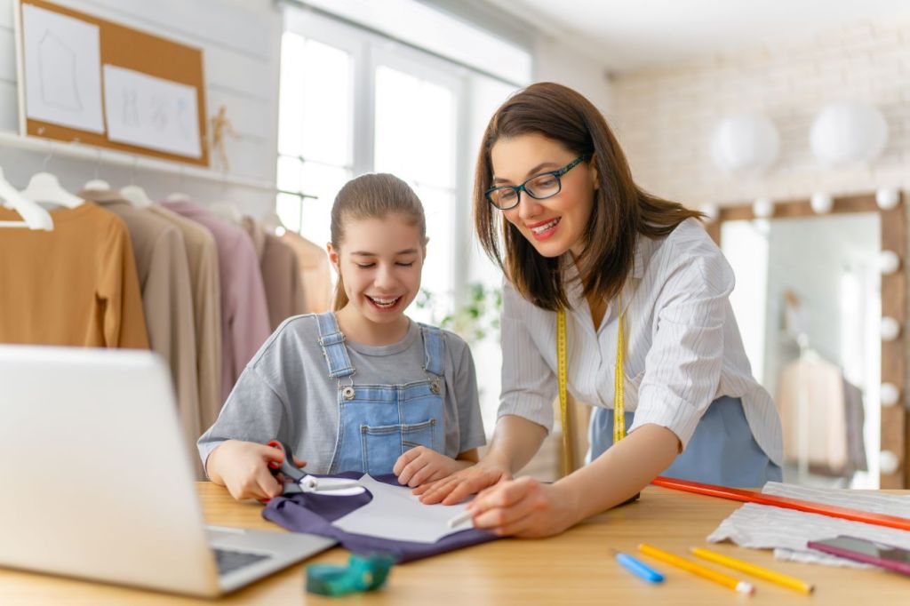 A mom teaching her teen daughter how to start a sewing business