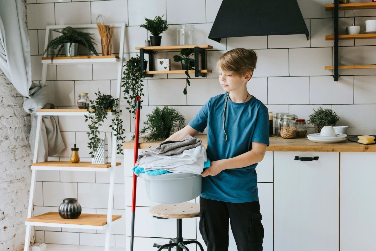 Teen boy doing chore of laundry