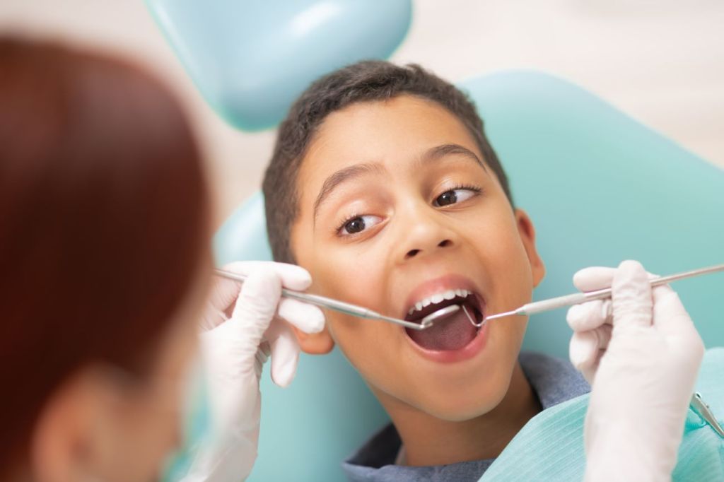 A young boy covered getting his teeth checked covered by dental insurance A young boy covered getting his teeth checked covered by dental insurance
