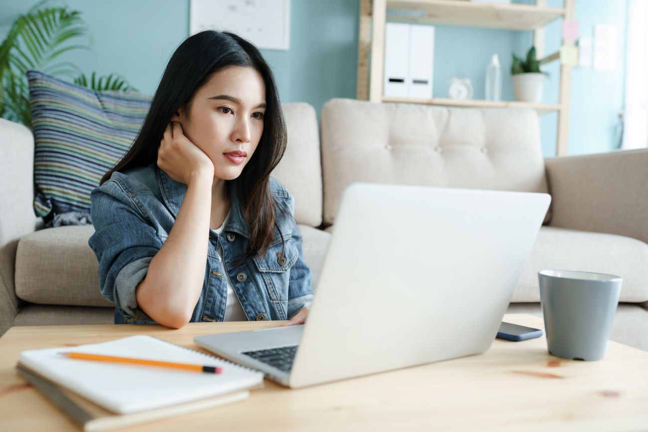 Young woman with laptop doing her income tax return