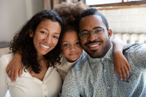 Smiling woman, girl, and man