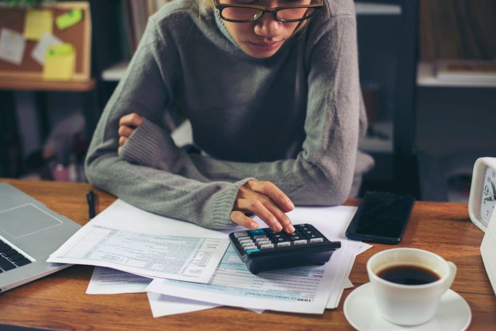 A teen calculating their earned income for tax filing in Canada