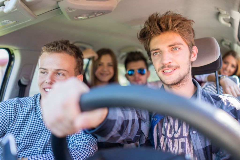 Teenagers driving a car with auto insurance