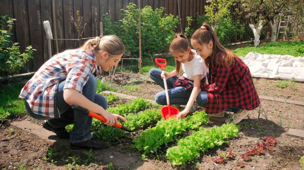 Kids helping their mother with gardening outside