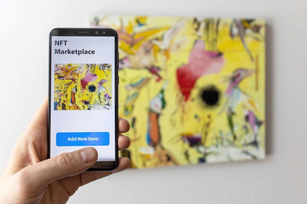 A teen buying NFT art on their phone from an NFT marketplace.