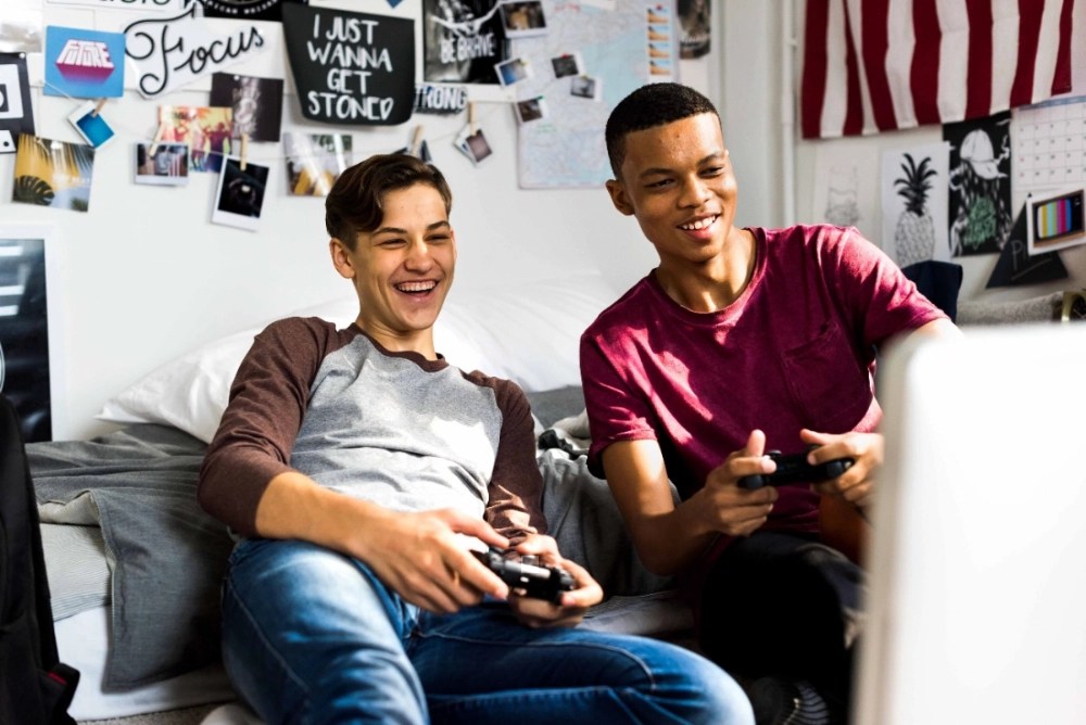 Two teenage boys playing a multiplayer game together