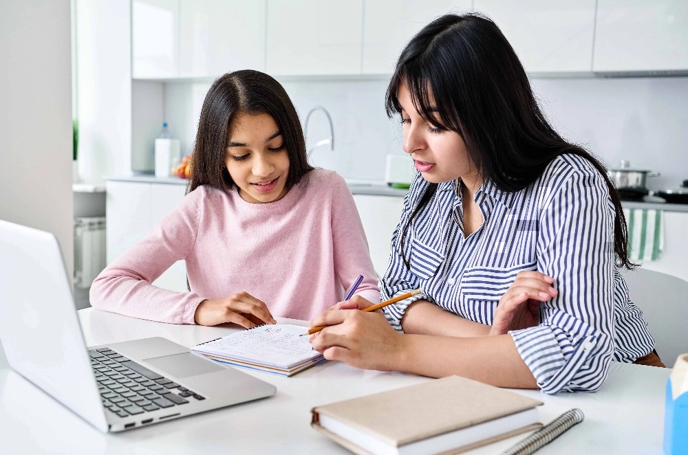 A mother teaching her daughter about money management for teens