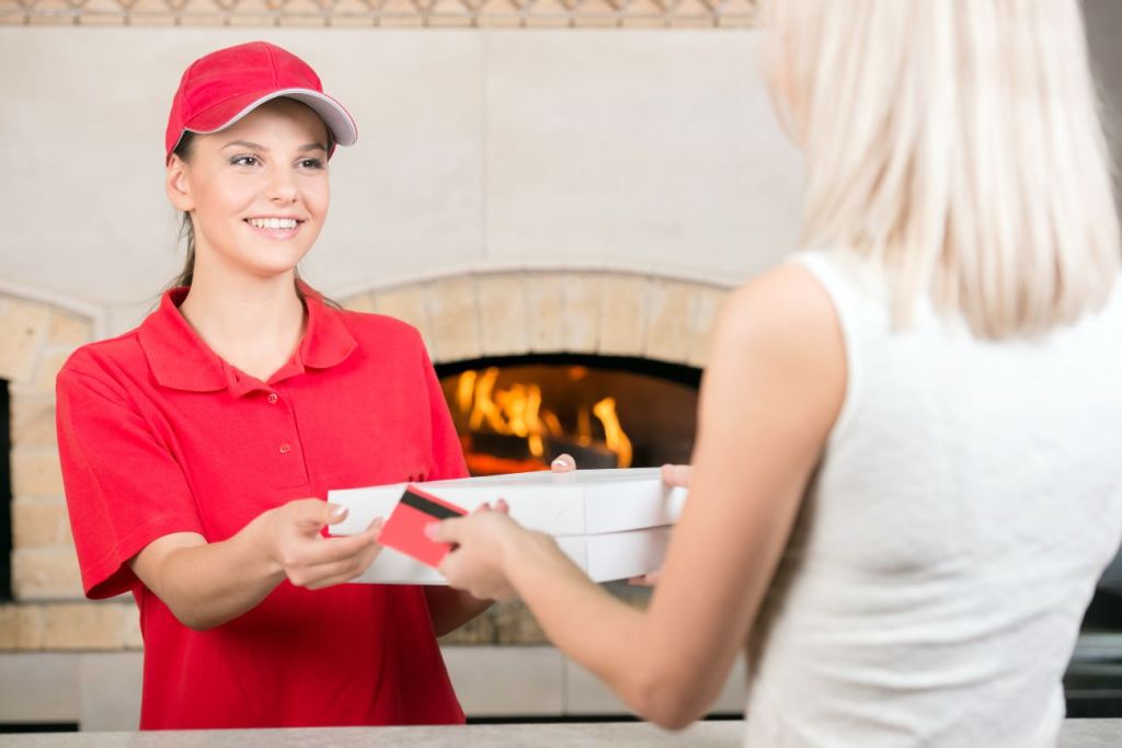 A teenage girl with a side gig serving pizza