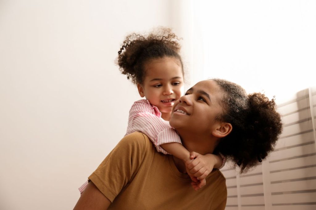 A young tween girl working part-time as a babysitter 