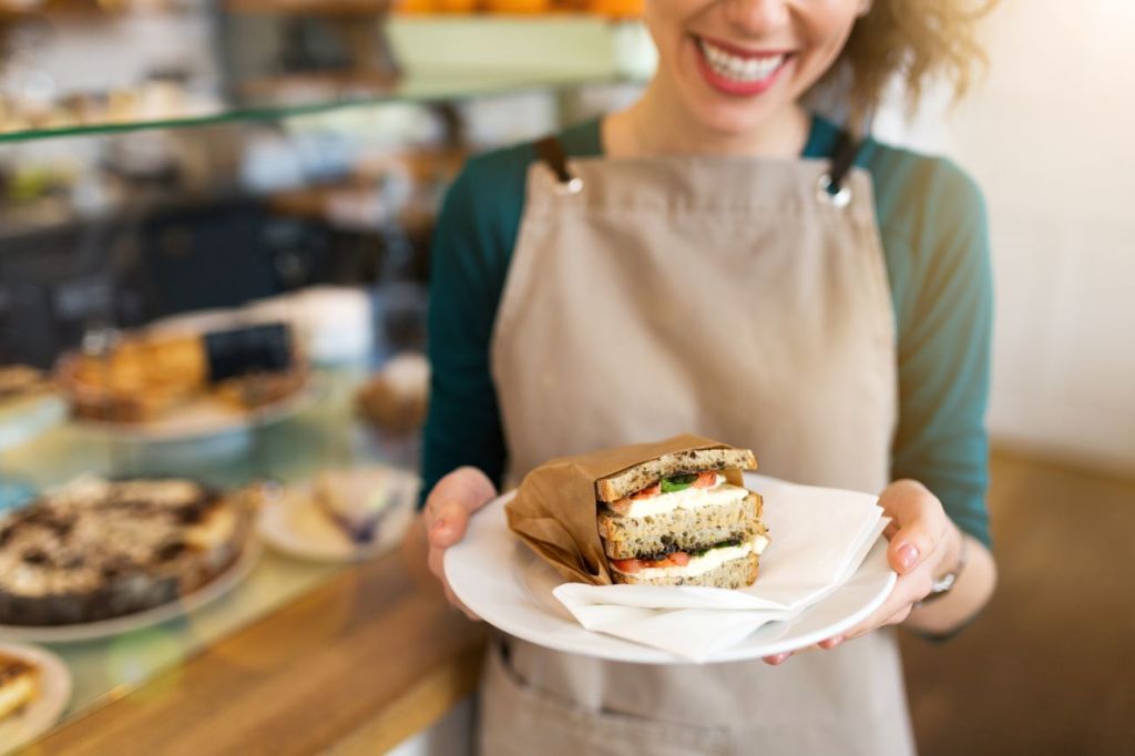 A 17-year girl working as a server in a restaurant to make money while in school