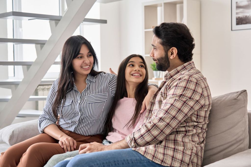 Family with woman, man and teen girl talking about finances