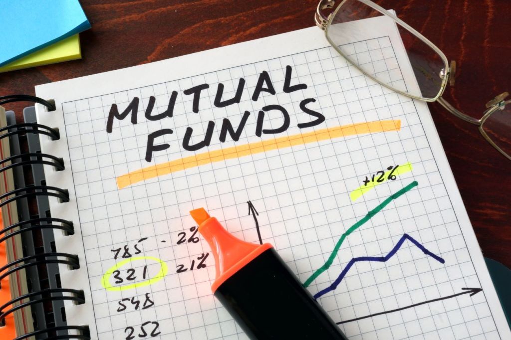 Notebook with the words "mutual funds" and an orange highlighter o
