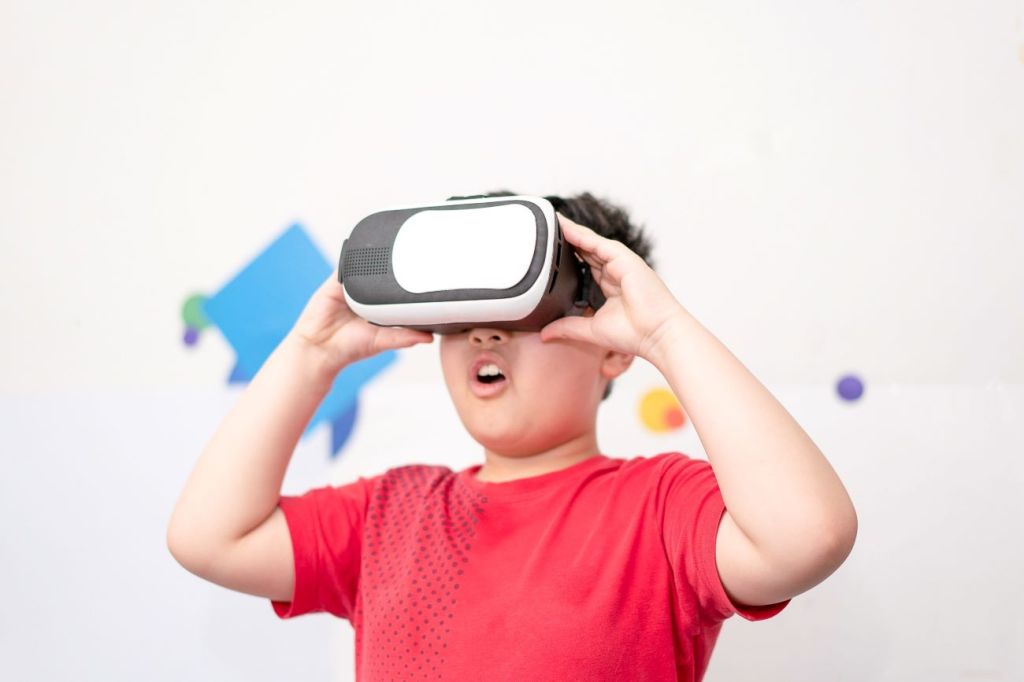 Boy wearing VR headset exploring the metaverse