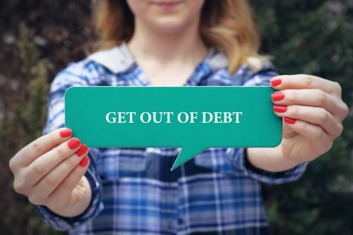 young woman holding sign saying get out of debt
