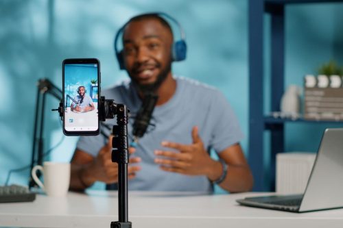 Black man wearing headphones recording a financial influencer video