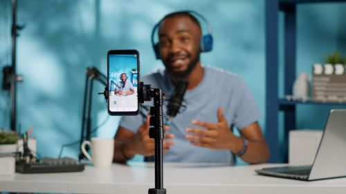 Black man wearing headphones recording a financial influencer video