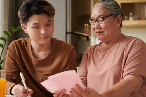 Kida and grandma making budget