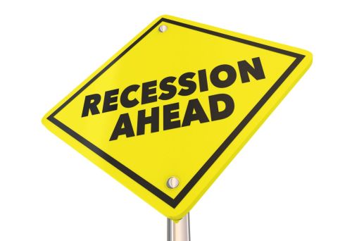Yellow diamond shaped sign saying recession ahead