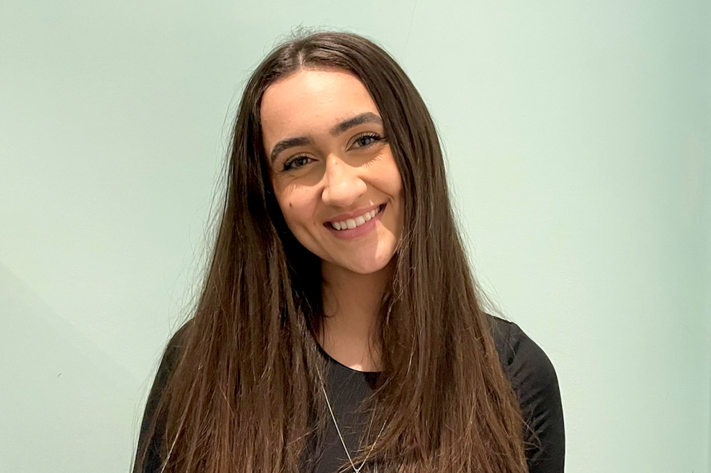 Image of Jada Malott, a teen girl with long brown hair, smiling against a green background.