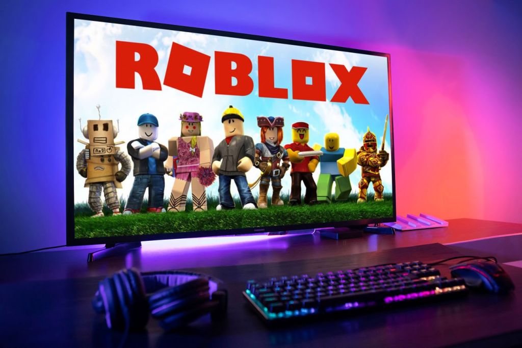 Image of Roblox logo with Roblox characters on video screen.