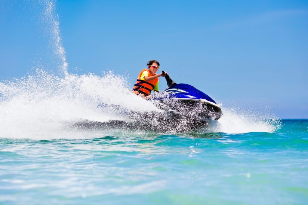 Teen boy on jet ski on holiday.