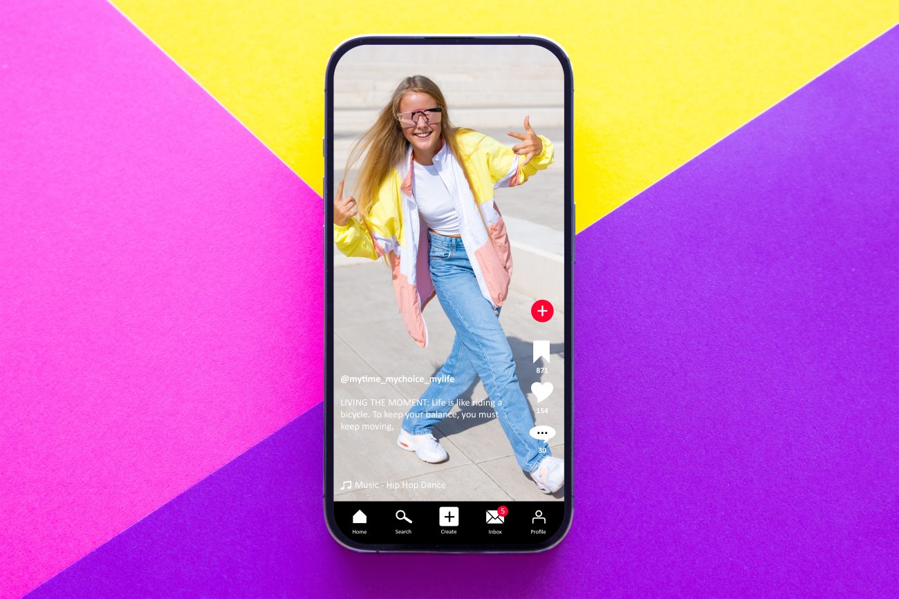 Image of teen influencer on smartphone with colourful background