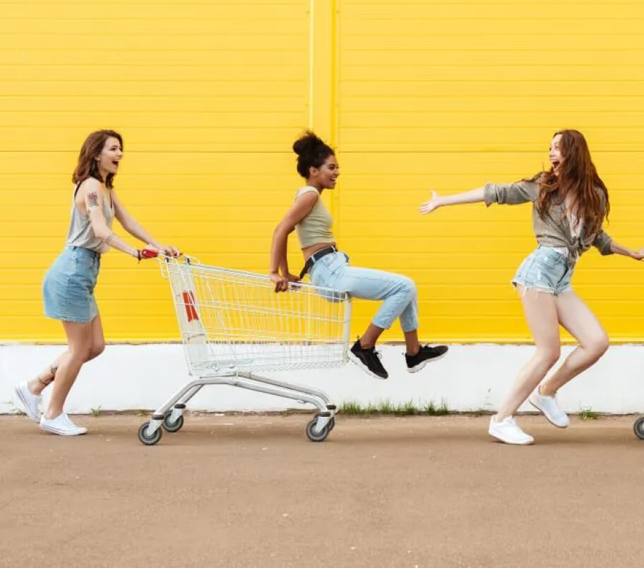 Teens playing with grocery cart