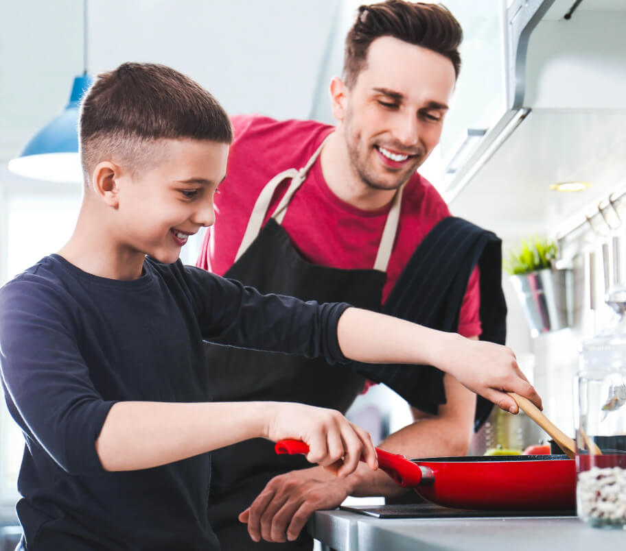 Dad teaching cooking to his son