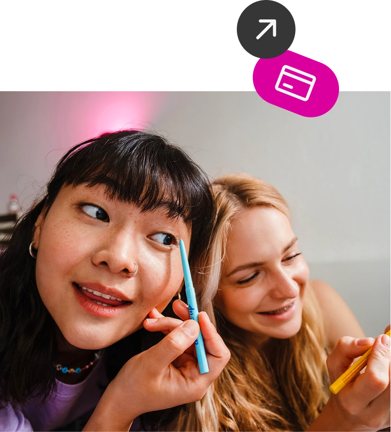 Two friends apply makeup together with app icons floating nearby, reflecting how Mydoh helps teens manage money and finance daily.